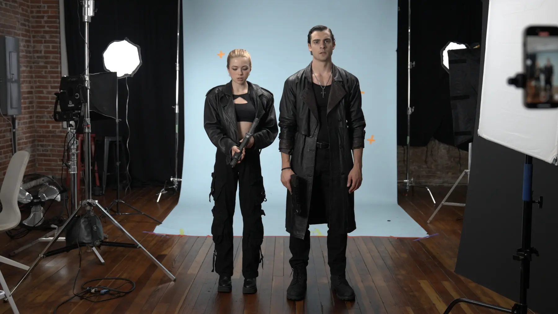 Two actors photographed on a greenscreen stage